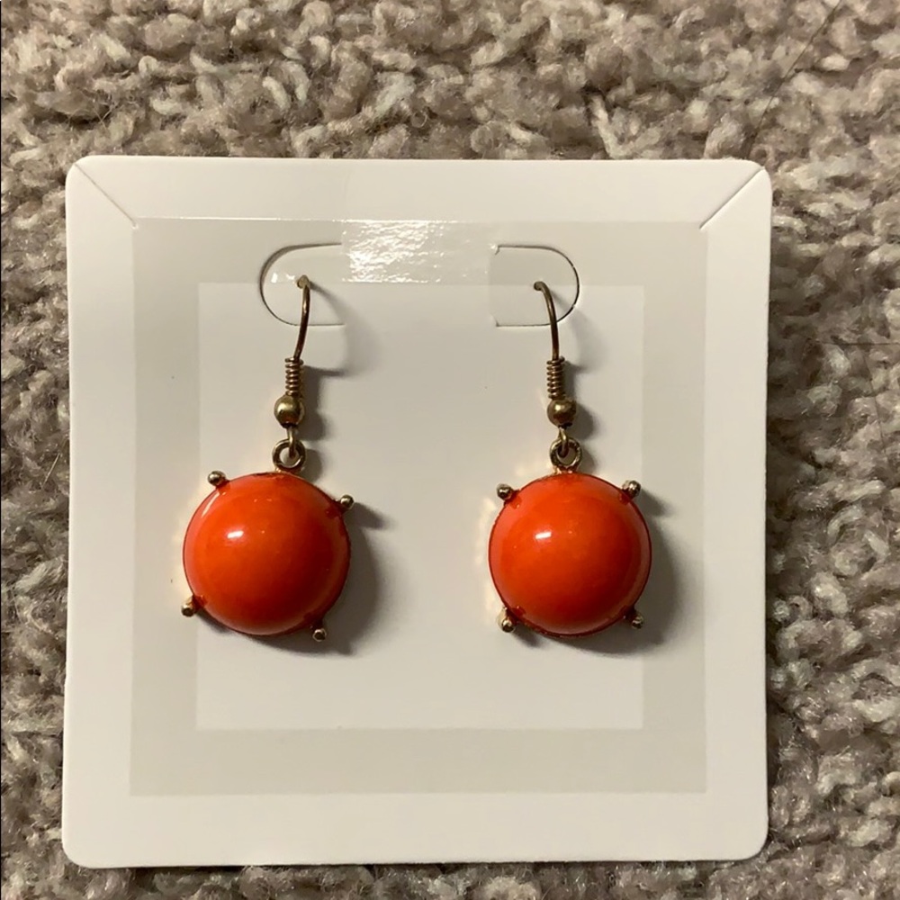 Orange and gold dangling earrings.